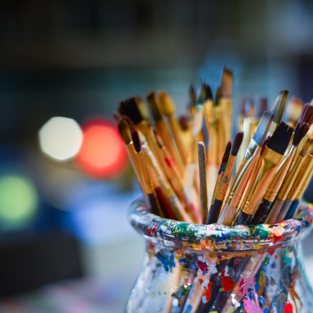 paint brushes in a glass jar