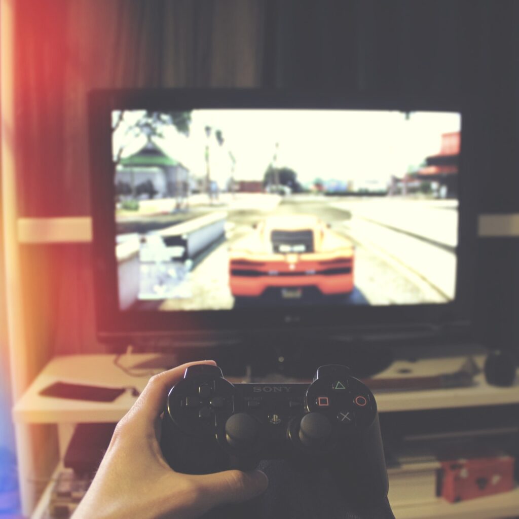 video games controller in front of a tv