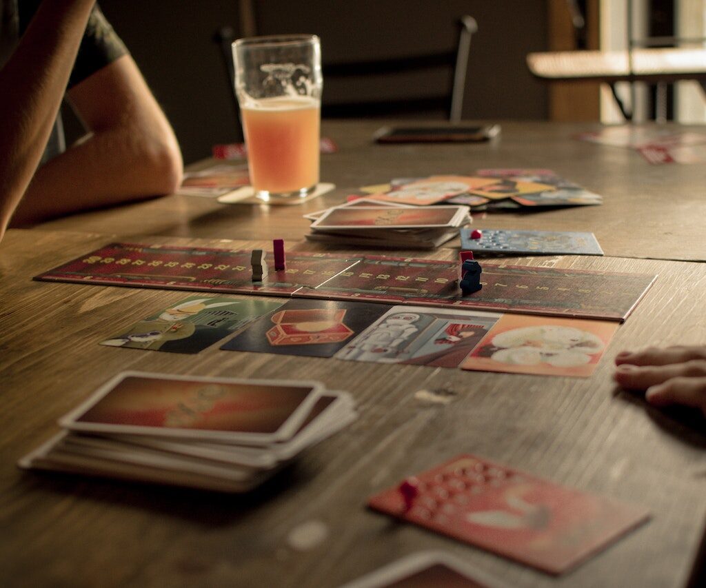 Board game on table with orange drink