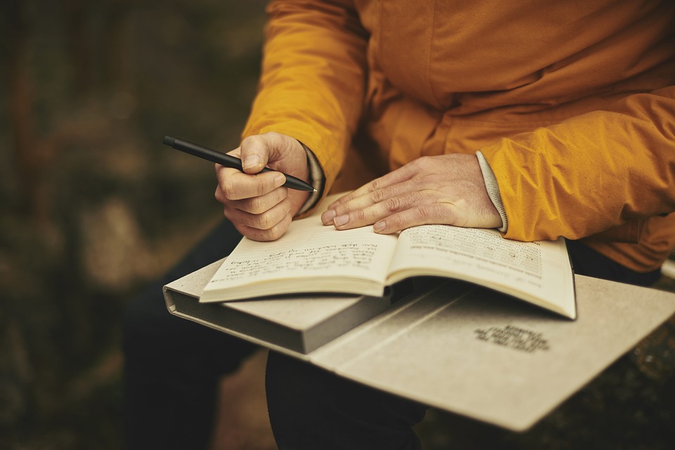 Person writing in a journal.