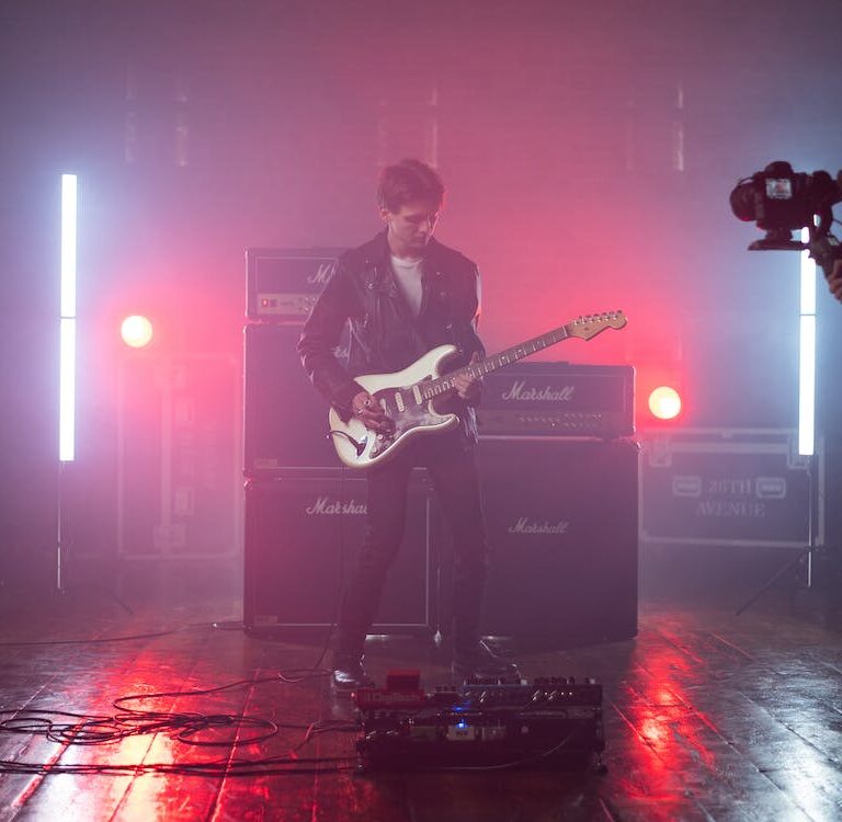 Cameraman recording a guitar player for a music video.