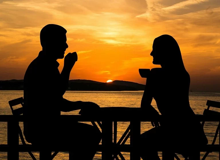 Silhouettes of a male and female couple during a sunset.
