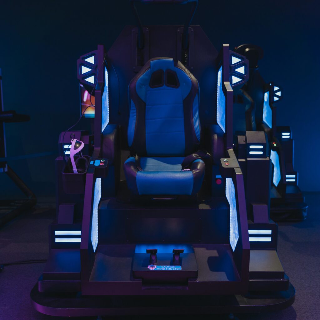 Video gamers chair with arm rests and a storage place for headphones.