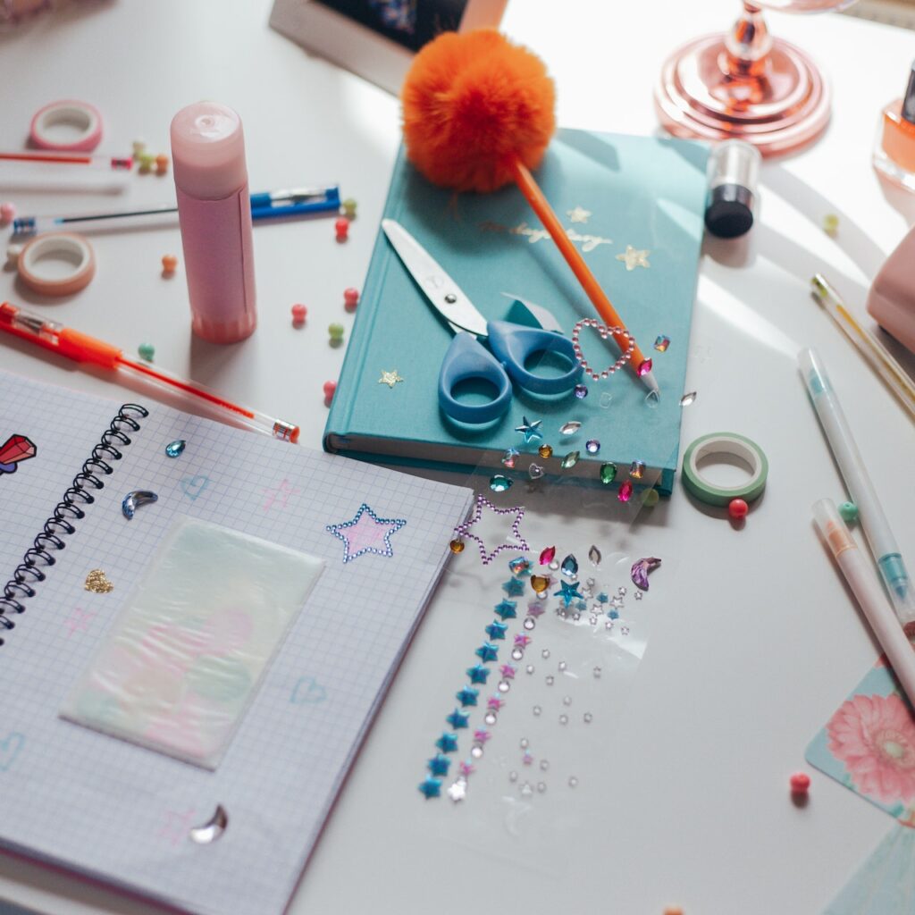 supplies for arts and crafts such as stickers, scissors and glue.