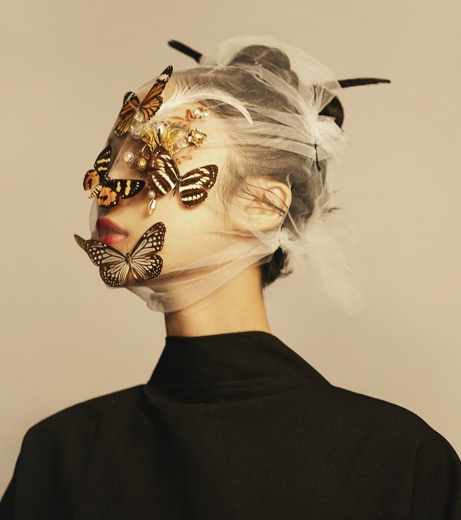 A women with butterflies on her face.