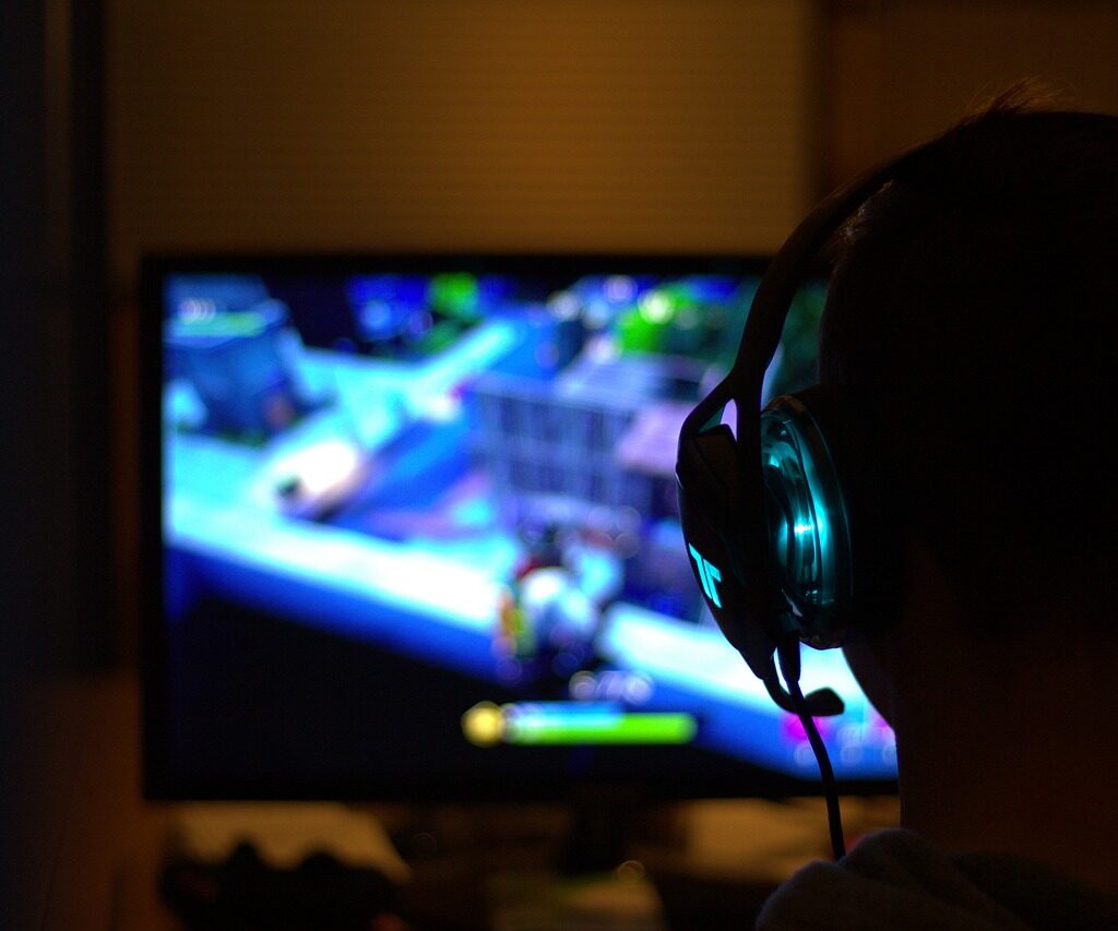 Gamer playing video games in front of TV.