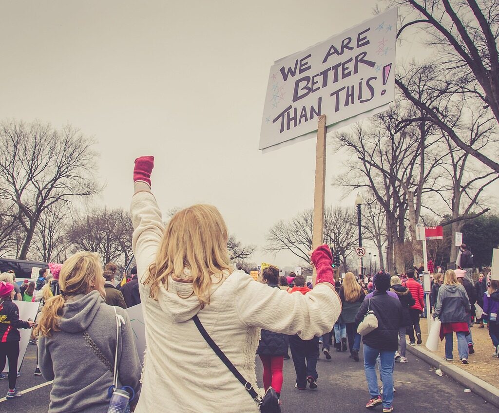 A woman holding up a sign during a protest.