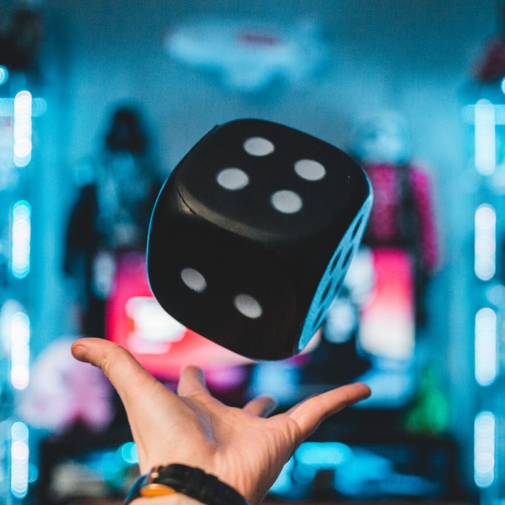 Hand throwing a large dice in the air