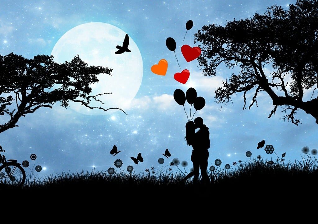 silhouette of couple kissing.