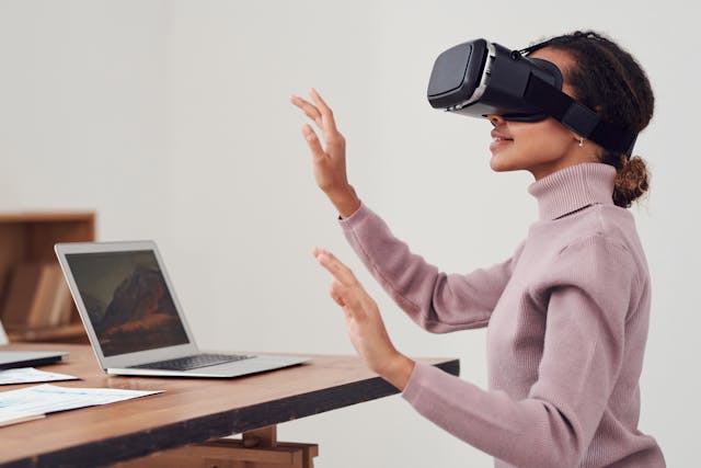 Woman with VR headset playing game.