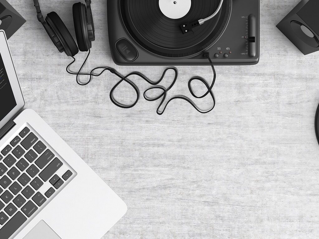 A laptop, headphones and a turntable.