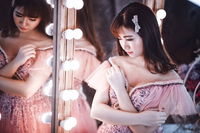 Woman in pink dress with ruffles and bow in hair, seemingly lolita fashion.