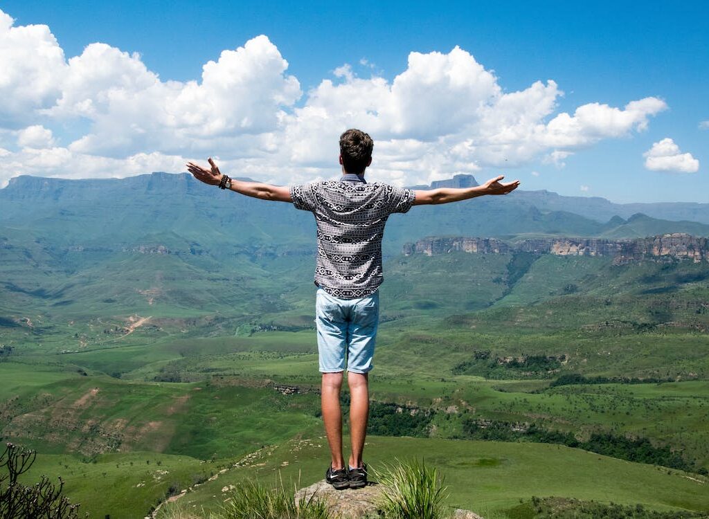 Single man in open mountain field.