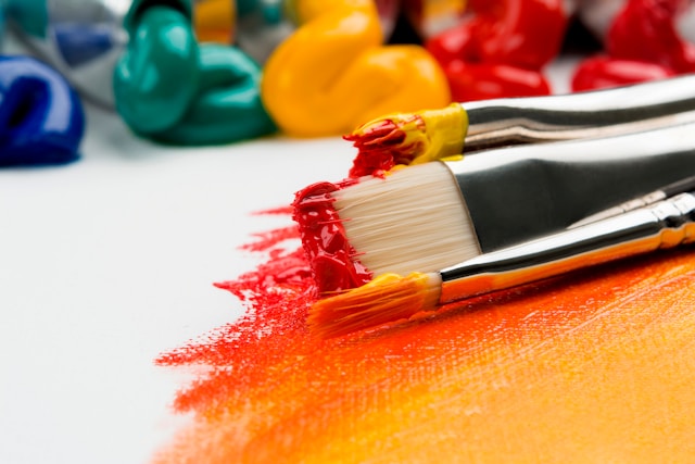 Image of color assorted paint and paint brushes. Featured in World Art Day article.