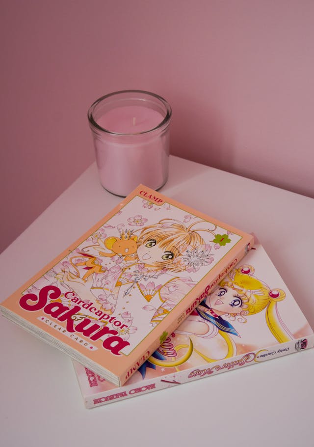 Sailor Moon and Cardcaptor Sakura on table, two shojo and magical girl comics or mangas.