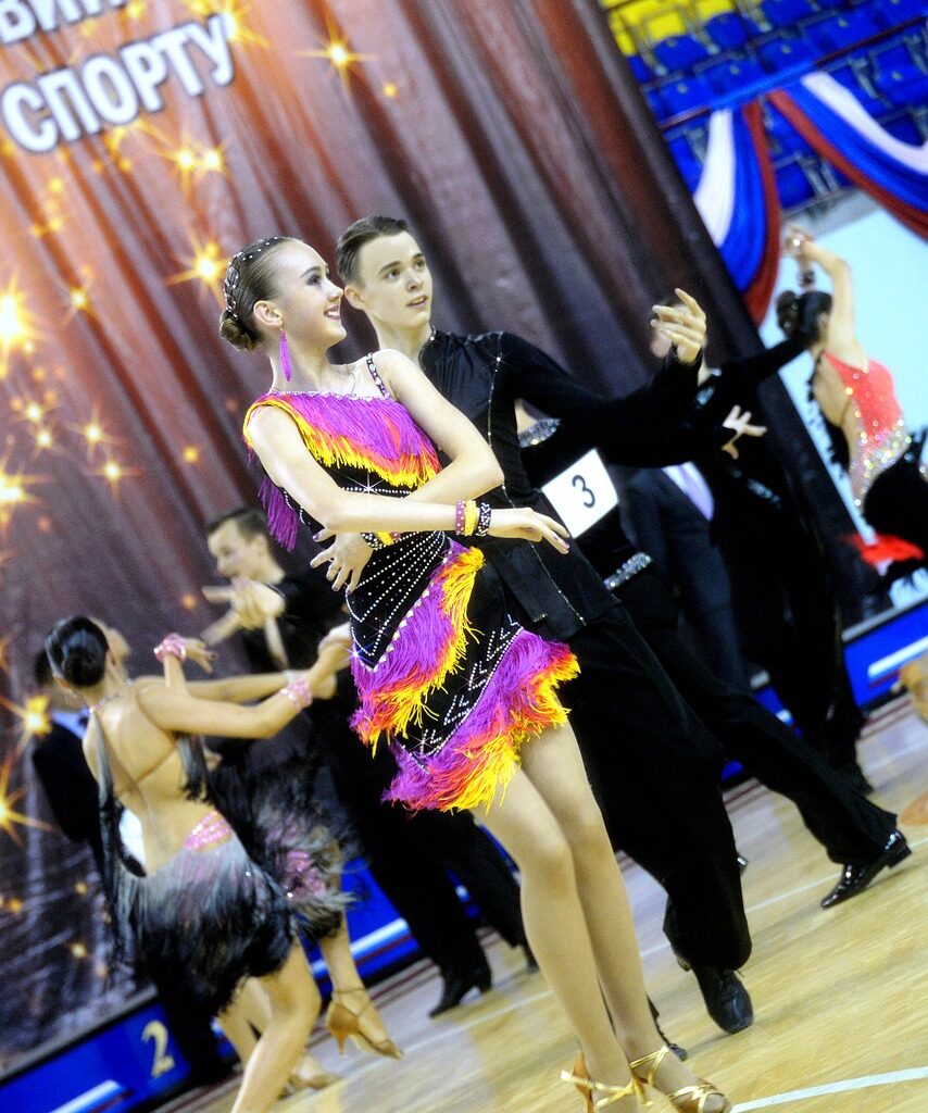 A boy and girl getting ready to ballroom dance.