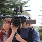 Person behind movie grade camera.