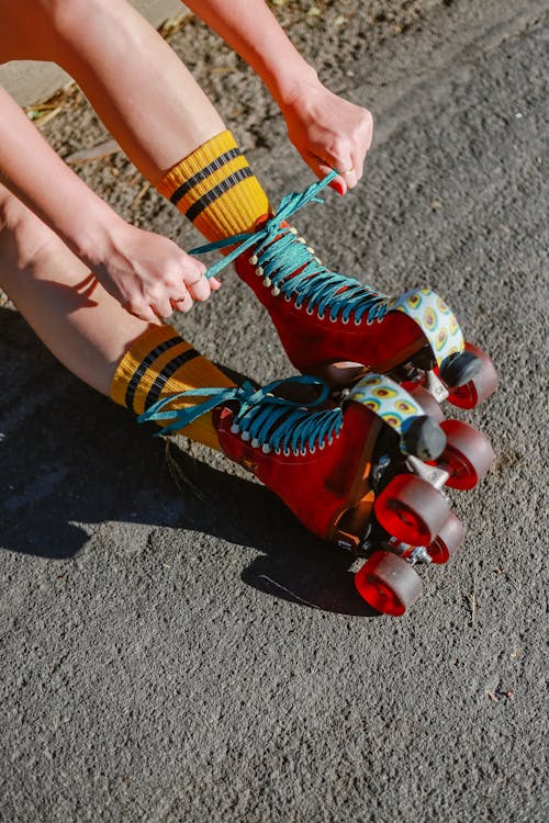 colorful red roller skates being laced up