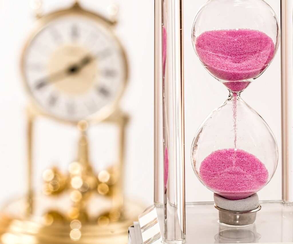 Image of visual timers including an hourglass with pink sand