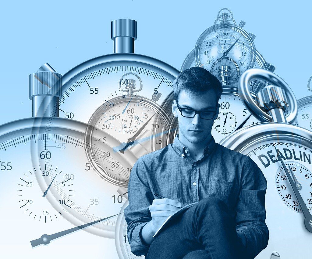 Man surrounded by clocks