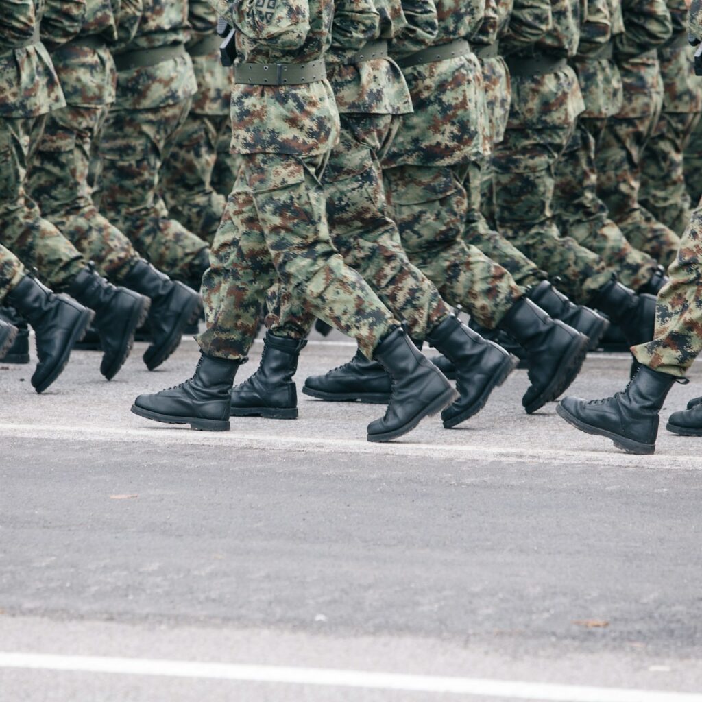 Close-up of soldiers' boots and legs marching in formation in camouflage uniforms, Women Army Corps Jobs